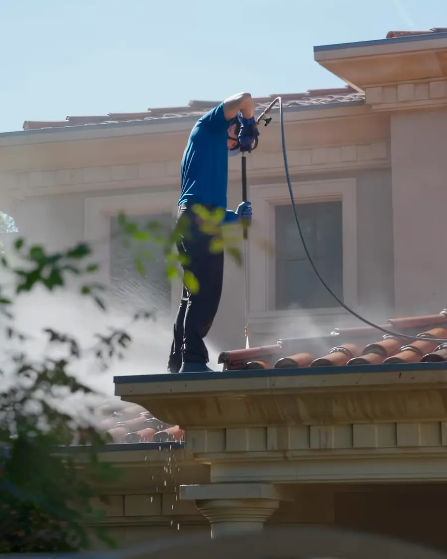 Titan crew member soft washing a stucco wall